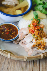 Delicious Hainanese chicken rice on wood background