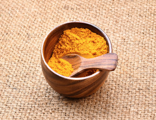 Turmeric powder on wooden background