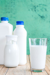 milk on a wooden table on Green background