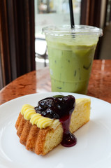 Closeup of a blueberry cheese cake with green tea
