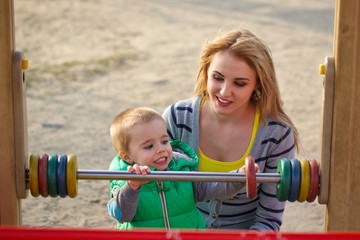 Fototapeta na wymiar Mother and son on the playground
