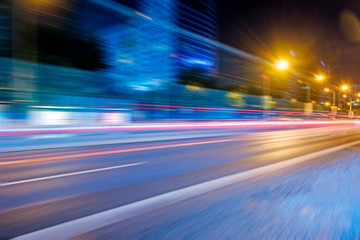 blurred traffic light trails on road at night in China.