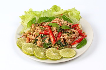 Fried spicy basil with minced pork topped sliced green lemon and and lettuce is top ten of popular Thai food.
