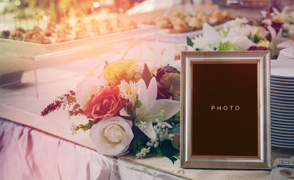 vintage blank frame and flower on table in wedding day