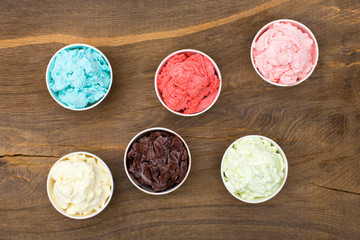 Ice-cream of different tastes in cups.