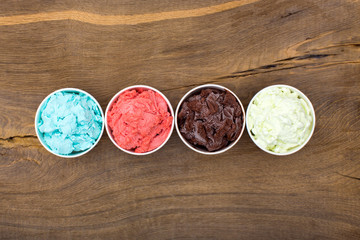 Bluleberry, strawberry, chocolate and creamy ice-cream in a row.