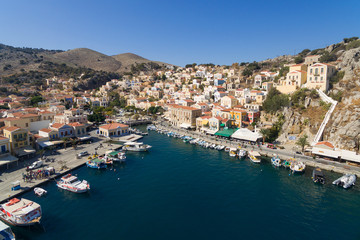 Symi island - Aerial image of Colorful houses and small boats at the heart of the village
