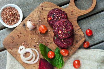 Beetroot burgers on the wooden board.