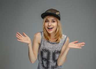 Portrait of positive blonde girl in military cap.