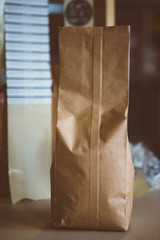 Coffee beans in brown paper bag