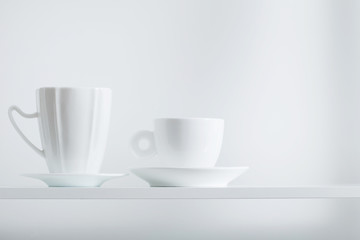 Clean cups on wooden shelf