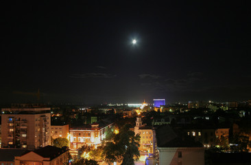 Fototapeta premium Krasnodar, Russia, at night with moon in the sky