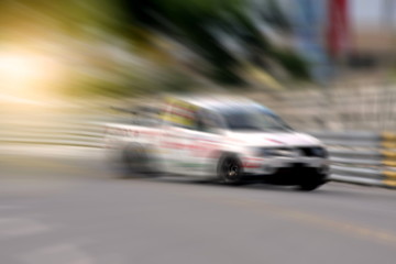 Race car racing on speed track with motion blur