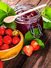 Strawberry on wood background. Strawberry with green leaves flow