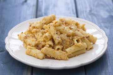 pasta with chicken on white dish on wooden background