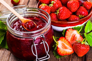 Strawberry on wood background. Strawberry with green leaves flow