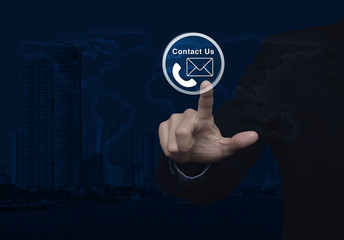 Businessman pressing telephone and mail icon button over world m