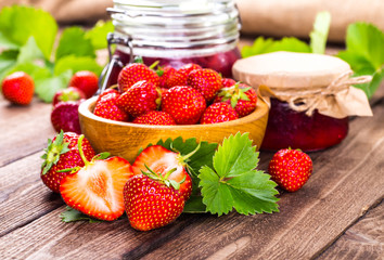 Strawberry on wood background. Strawberry with green leaves flow