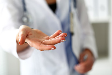 Fototapeta na wymiar Female medicine doctor offering helping hand closeup
