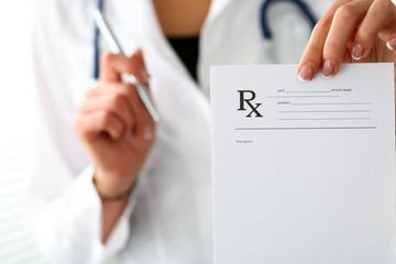 Female medicine doctor hand give prescription to patient © megaflopp