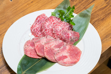 raw beef meat on white plate
