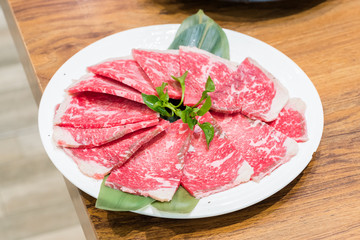 raw beef meat on white plate
