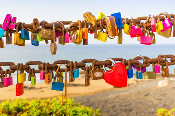 Padlocks of love on rusty chain seaview