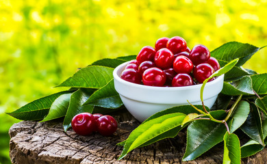 Fresh ripe cherries with jam on a wooden table.