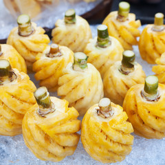Pineapple fruit on ice in the market