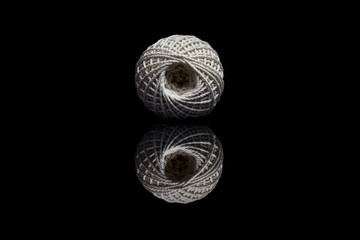 Front view of white ball of string on black background