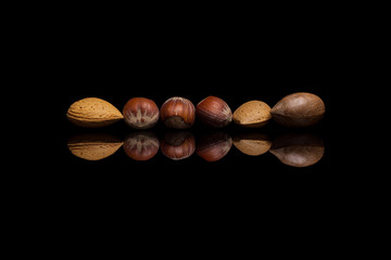 Six unshelled nuts, two almonds, one pecan and three hazelnuts i