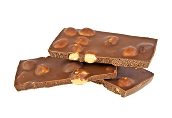 Milk chocolate with nuts on a white background, closeup