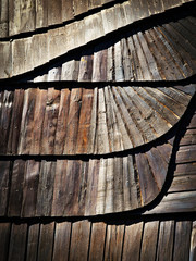Detail of wooden shingle roof with a tilde