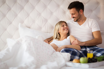 Obraz na płótnie Canvas Romantic couple having breakfast in bed