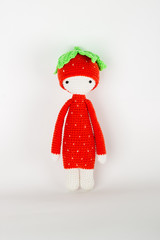 soft toy crochet a red strawberry in a white cap and scarf
