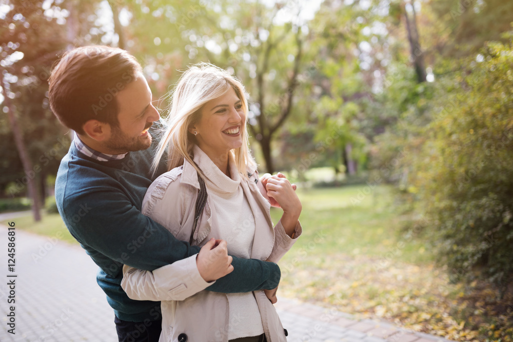 Wall mural Loving couple walking in park