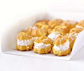 Cream puff cakes with custard in a white box