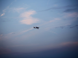 Small aeroplane flies in sky
