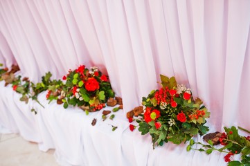 Fototapeta na wymiar Decor wedding flowers on wedding table of newlywed