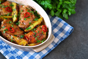 Baked, marinated chicken with potatoes and rosemary
