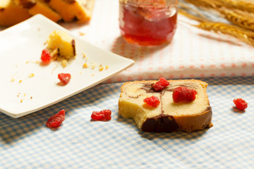 Pieces of chocolate marble and butter cake on wooden table
