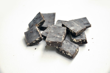 dark chocolate pieces on white background
