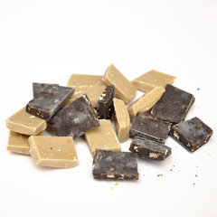 dark and white chocolate pieces on white background