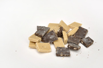 dark and white chocolate pieces on white background