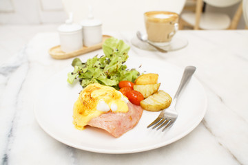 Egg benedict ham on toast breakfast with coffee