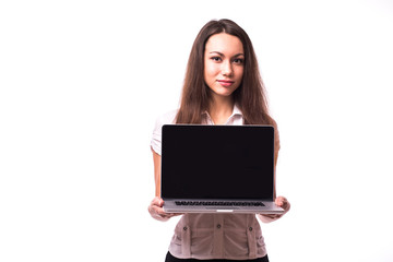 Smiling pretty young woman with friendly happy smile holding a laptop computer and pointing at screen where you add your marketing message
