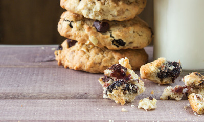 Closeup of pile made from homemade moms chocolate cookies and glass of milk