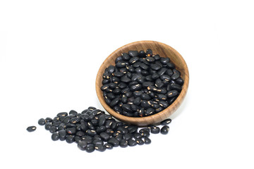 Fototapeta na wymiar Wooden bowl of dry black beans on white