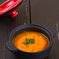 pumpkin soup in a small black pot