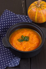 Pumpkin soup on a wooden table